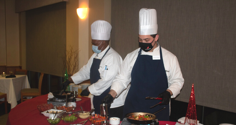 Students of the Academy of Culinary Arts serve food during the President's Holiday Reception