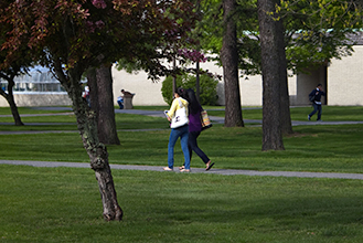 person walking across campus