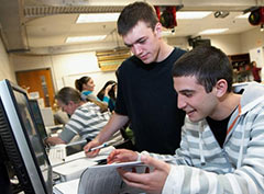 Students learning together on a computer