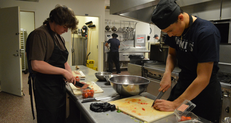 St. Augustine Prep students chop vegetables in one of the kitchens of the Academy of Culinary Arts on the Mays Landing campus.