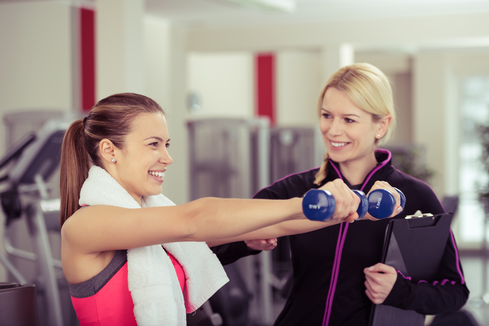 Trainer and patient doing exercise in a gym