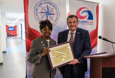 Atlantic Cape President Dr. Barbara Gaba receives a proclamation from Assemblyman John Risley