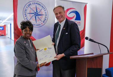 Atlantic Cape President Dr. Barbara Gaba receives a proclamation from Robert Geist