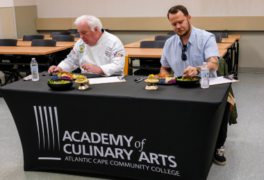 Judges Chef Anthony Todaro and Chef Josh Romano tasting the student culinary creations